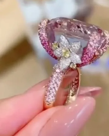 Blush Bloom cocktail ring with a pink oval stone and white flower